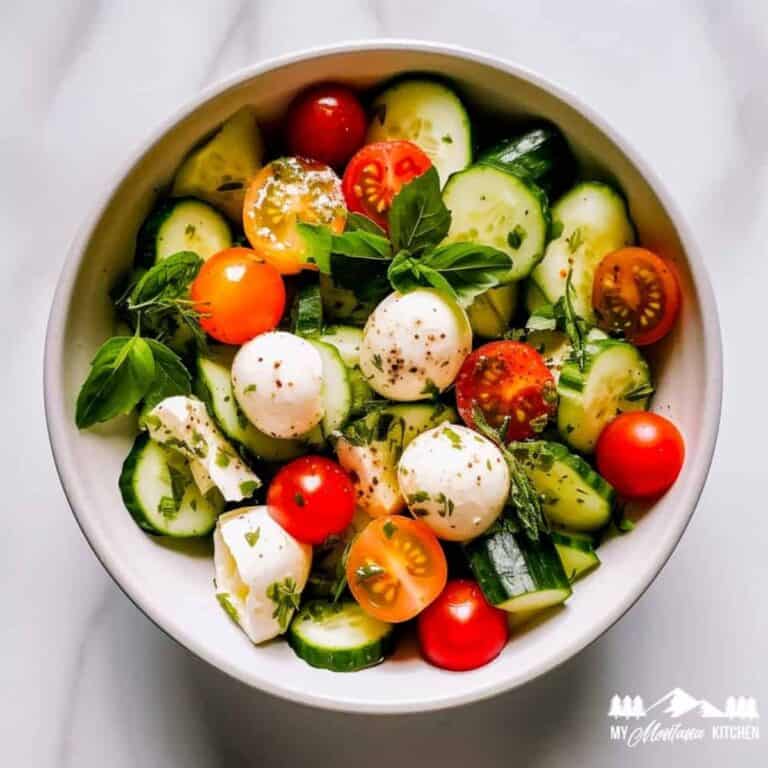 cucumber, mozzarella, tomato salad in white bowl