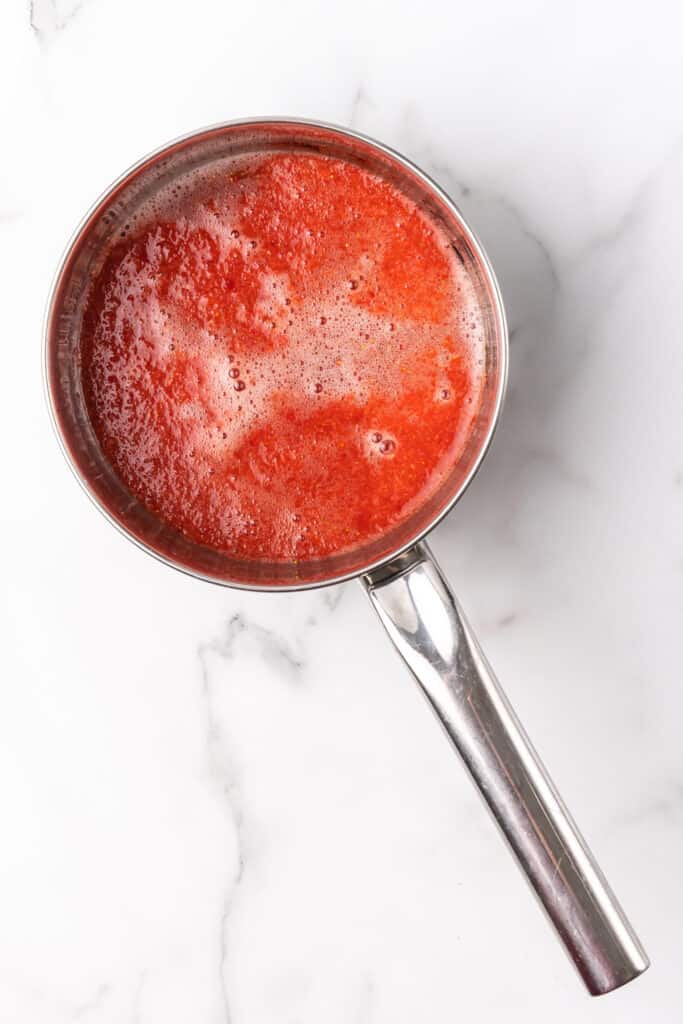 warm strawberry gelatin mixture in pot