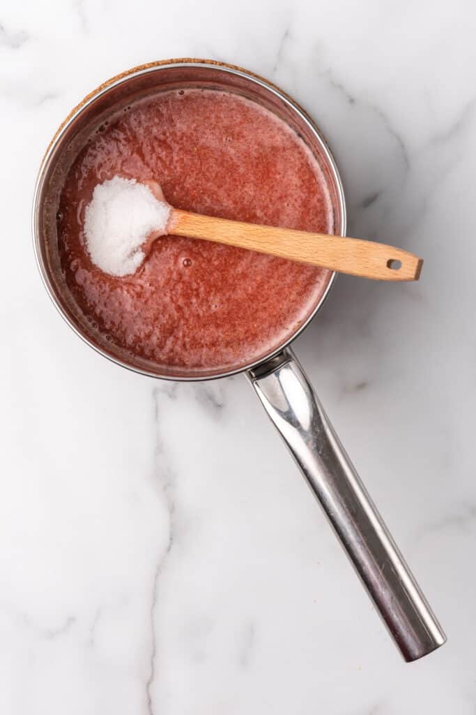 strawberry gelatin mixture in pot with sweetner