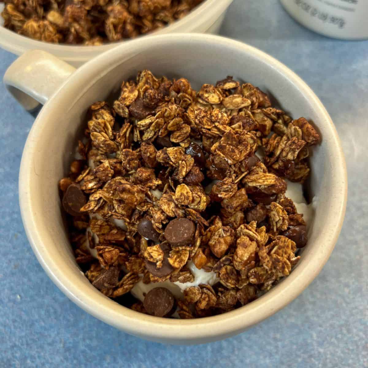 chocolate air fryer granola in mug with yogurt