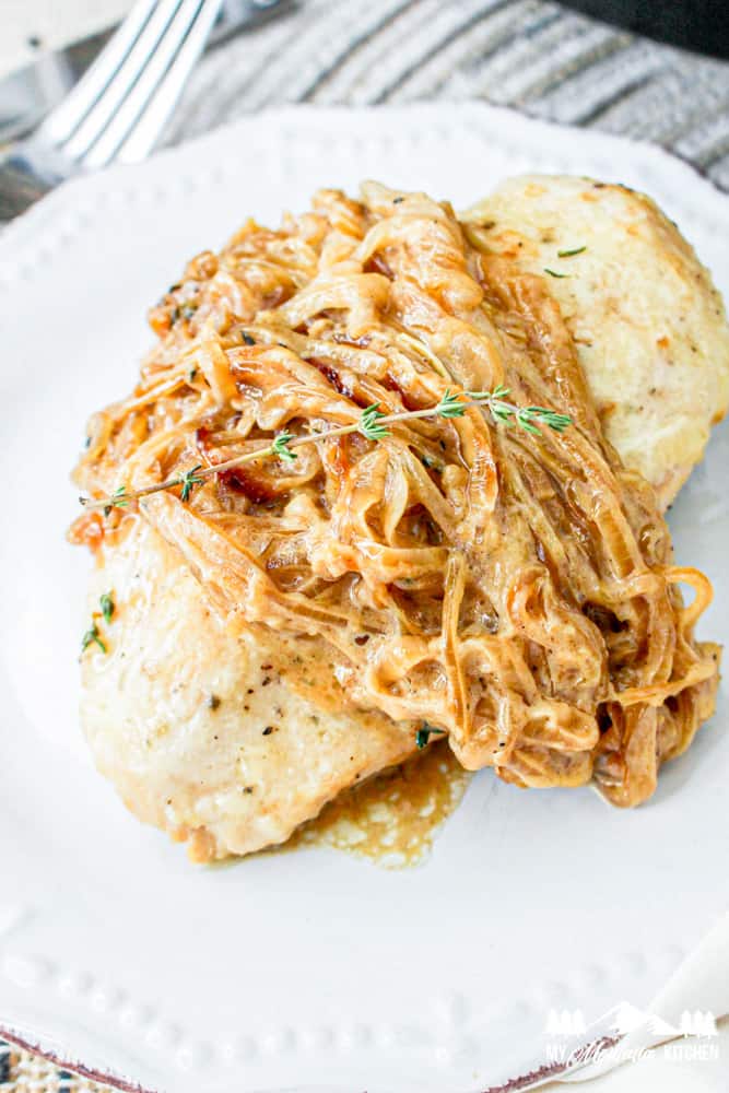 french onion chicken with caramelized onions on white plate