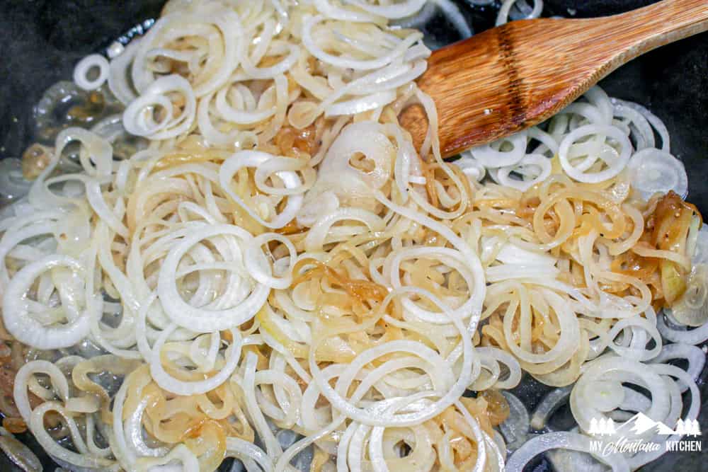 partially cooked onions in skillet