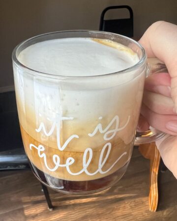 foamy latte in glass mug