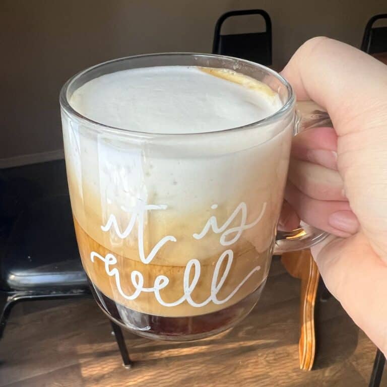 foamy latte in glass mug