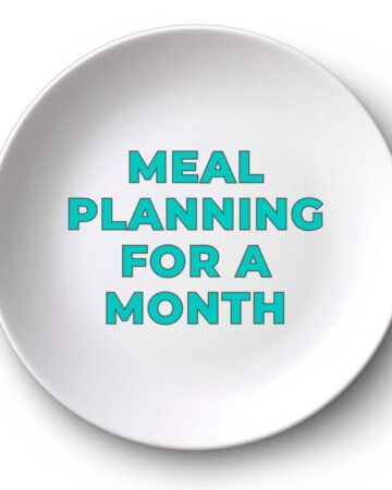 white plate with the words "meal planning for a month" written in teal letters