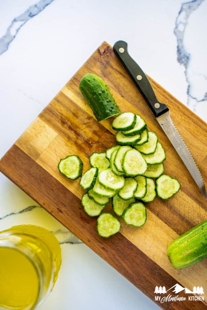 sliced cucumbers on cutting board