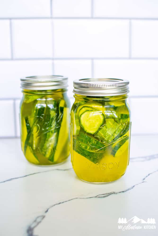 cucumbers in pickle juice in glass jars