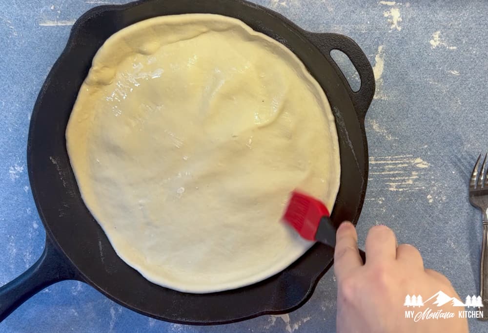 sourdough pizza dough in cast iron skillet