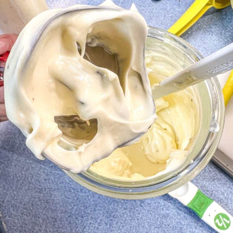 homemade avocado oil mayo on immersion blender blades