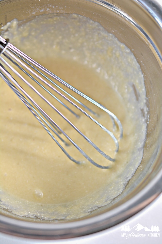 cake batter in bowl with wire whisk