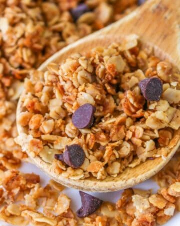 nut free granola with mini chocolate chips on wooden spoon