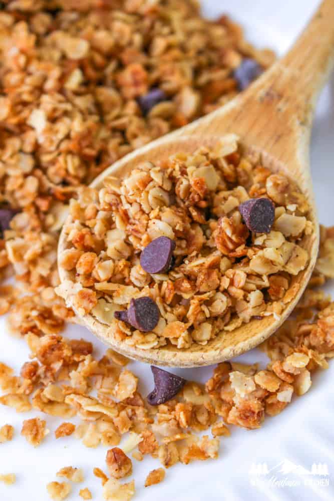 nut free granola with chocolate chips on wooden spoon