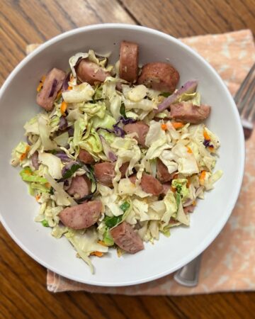 cabbage and sausage in white bowl