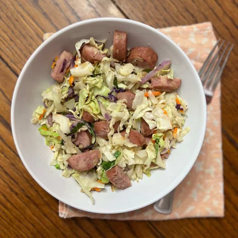 cabbage and sausage in white bowl