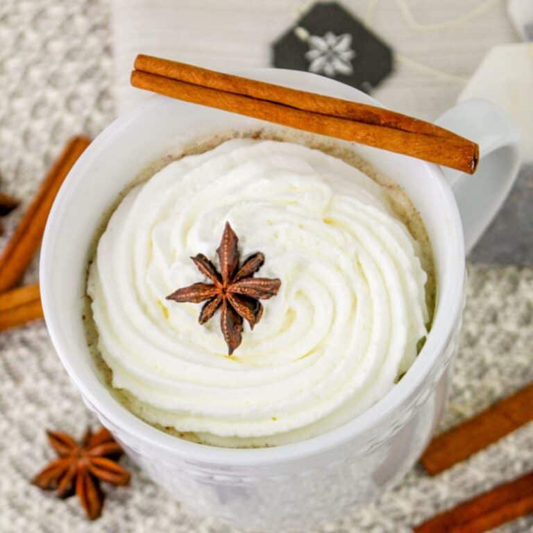 pumpkin spice chai latte with whipped cream and cinnamon stick