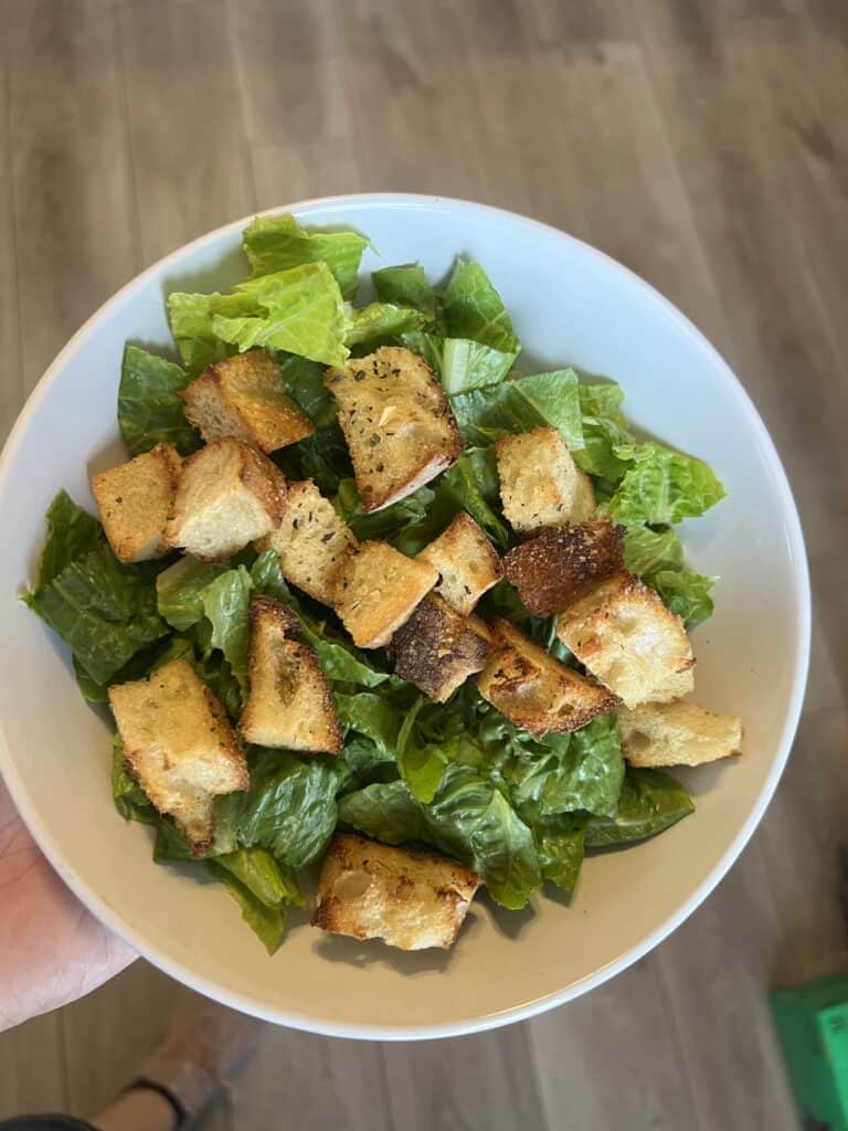 A fresh green salad topped with golden, crunchy homemade croutons made in the air fryer