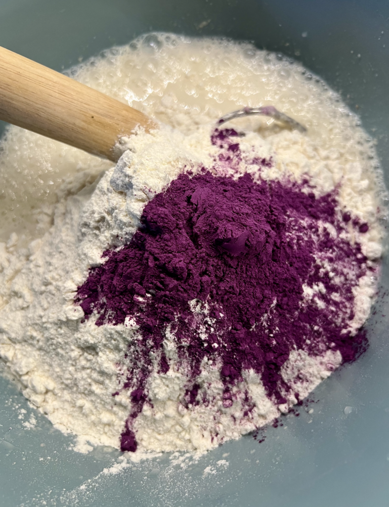 Ube powder added to sourdough sandwich bread dough for natural purple color, showing purple sweet potato powder mixed with flour and sourdough starter