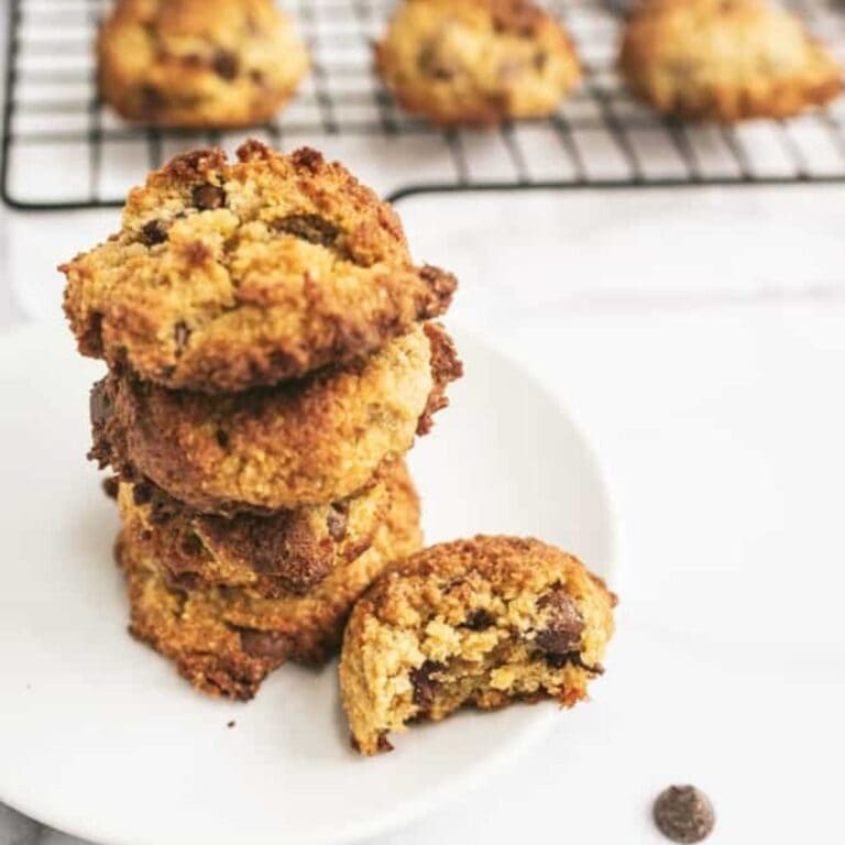 unbaked cookie dough on cookie sheet with mixing bowl beside
